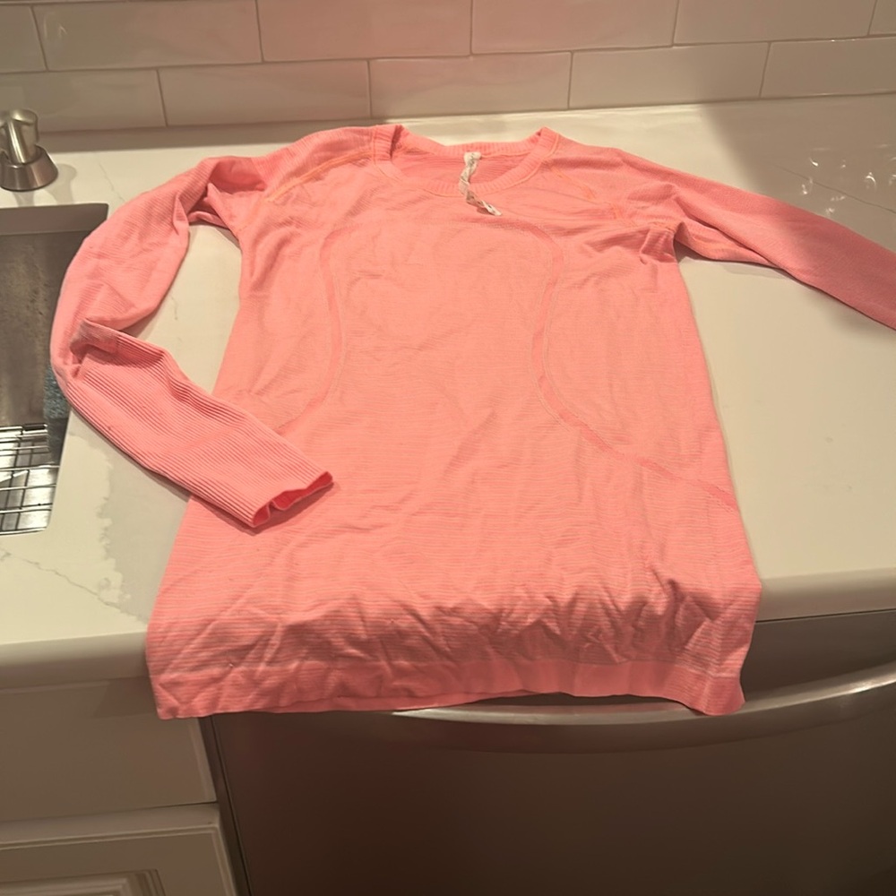 Lululemon swiftly tech in pinkish peach color.